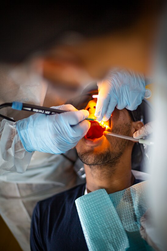 U.S. service members provide dental care to a patient at Yauco, Puerto Rico, April 28, 2019, during Innovative Readiness Training Puerto Rico. IRT Puerto Rico is also called Ola de Esperanza Sanadora, which translates to Healing Wave of Hope. This IRT is part of a civil and joint military program to improve military readiness while simultaneously providing quality services to underserved communities throughout the United States. (U.S. Marine Corps photo by Sgt. Andy O. Martinez)