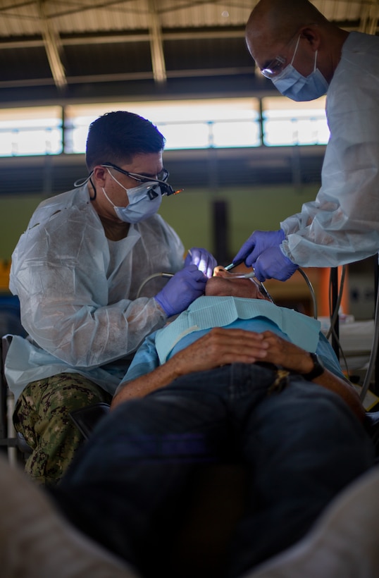 A U.S. Navy Sailor provides dental care to a patient at Yauco, Puerto Rico, April 28, 2019, during Innovative Readiness Training Puerto Rico. IRT Puerto Rico is also called Ola de Esperanza Sanadora, which translates to Healing Wave of Hope. This IRT is part of a civil and joint military program to improve military readiness while simultaneously providing quality services to underserved communities throughout the United States. (U.S. Marine Corps photo by Sgt. Andy O. Martinez)