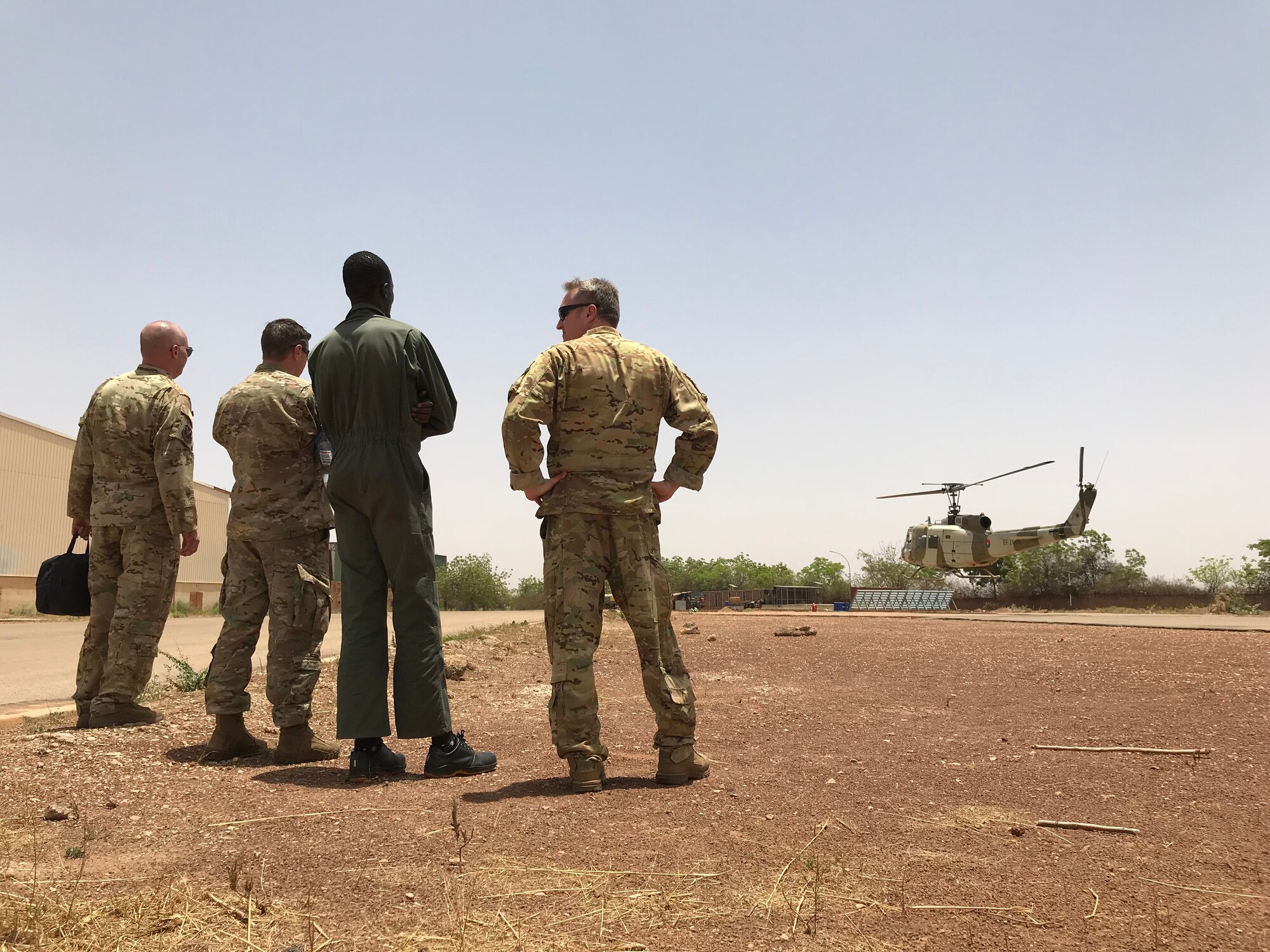 Air Advisors observe a hover check by the Burkina Faso Air Force at Airbase 511 in Burkina Faso, Africa, April 10, 2019. The 818 MSAS sent a seven member Rotary Wing Maintenance and Operations mobile training team to identify the cause of a significant maintenance issue that had grounded the Burkina Faso Air Force’s UH-1H helicopter fleet for nearly a year. (U.S. Air Force photo by Master Sgt. Sarah Colwell)