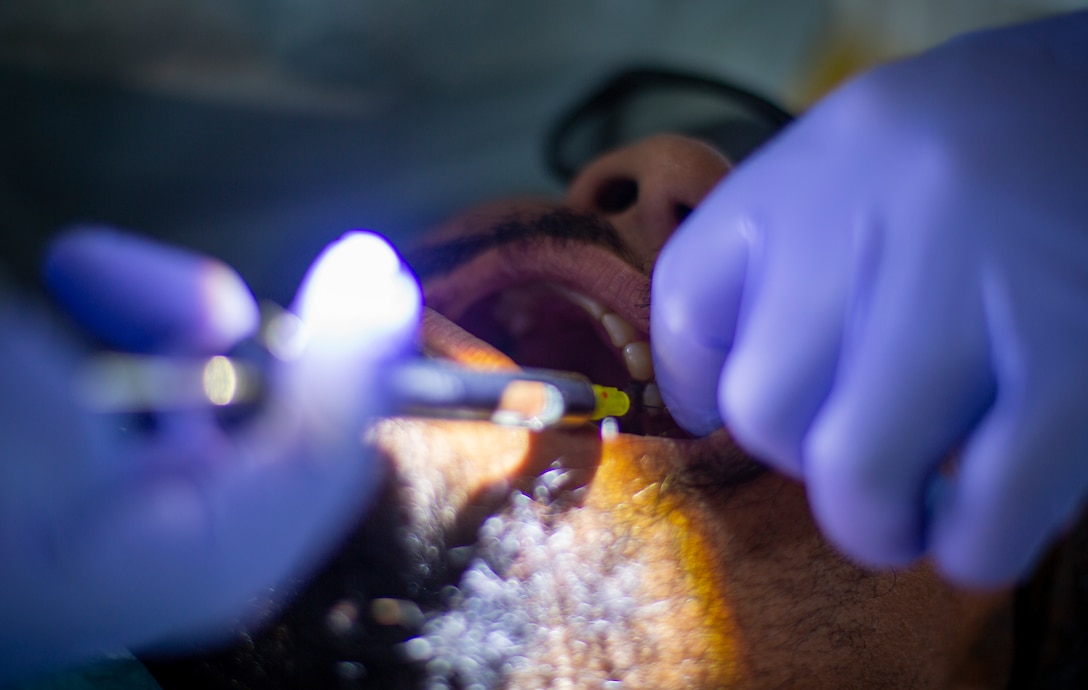 U.S. Navy Lt. Cmdr. Kevin Smith, a general dentist with 4th Dental Battalion, 4th Marine Logistics Group, Marine Forces Reserve, examines a patient’s teeth at Yauco, Puerto Rico, April 28, 2019, during Innovative Readiness Training Puerto Rico. IRT Puerto Rico is also called Ola de Esperanza Sanadora, which translates to Healing Wave of Hope. This IRT is part of a civil and joint military program to improve military readiness while simultaneously providing quality services to underserved communities throughout the United States. (U.S. Marine Corps photo by Sgt. Andy O. Martinez)