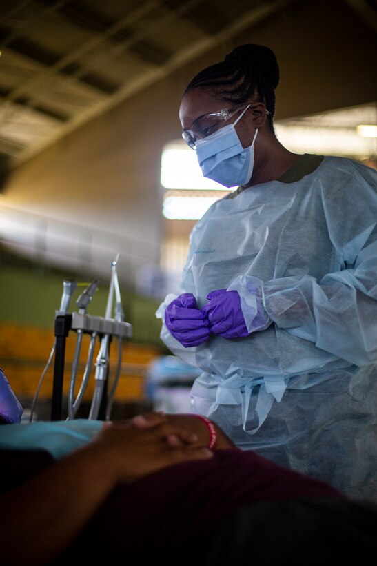 U.S. Navy Petty Officer 3rd Class Carlotta Howard, a dental technician with 4th Dental Battalion, 4th Marine Logistics Group, Marine Forces Reserve, provides dental care to a patient at Yauco, Puerto Rico, April 28, 2019, during Innovative Readiness Training Puerto Rico. IRT Puerto Rico is also called Ola de Esperanza Sanadora, which translates to Healing Wave of Hope. This IRT is part of a civil and joint military program to improve military readiness while simultaneously providing quality services to underserved communities throughout the United States. (U.S. Marine Corps photo by Sgt. Andy O. Martinez)