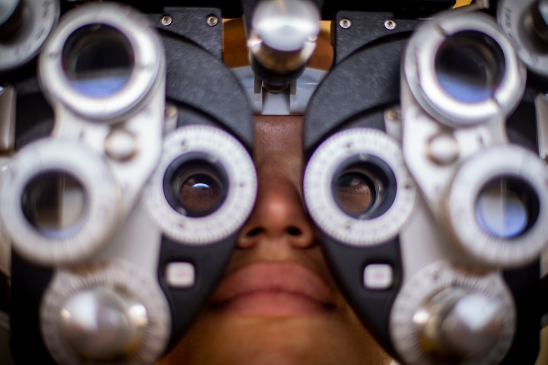 A patient looks through an illuminated phoropter refracting instrument at Yauco, Puerto Rico, April 28, 2019, during Innovative Readiness Training Puerto Rico. IRT Puerto Rico is also called Ola de Esperanza Sanadora, which translates to Healing Wave of Hope. This IRT is part of a civil and joint military program to improve military readiness while simultaneously providing quality services to underserved communities throughout the United States. (U.S. Marine Corps photo by Sgt. Andy O. Martinez)
