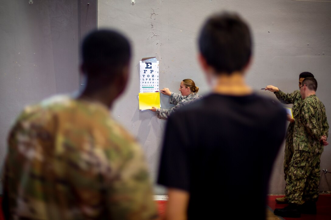 U.S. service members examine a patient’s vision at Ponce, Puerto Rico, April 28, 2019, during Innovative Readiness Training Puerto Rico. IRT Puerto Rico is also called Ola de Esperanza Sanadora, which translates to Healing Wave of Hope. This IRT is part of a civil and joint military program to improve military readiness while simultaneously providing quality services to underserved communities throughout the United States. (U.S. Marine Corps photo by Sgt. Andy O. Martinez)