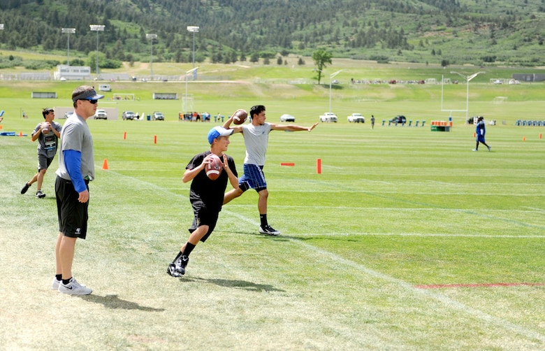 Youth sharpen their football skills during a youth football camp. Air Force Youth Programs is offering a variety of summer camps for 2019 to include more than 10 sports camps. (U.S. Air Force photo)