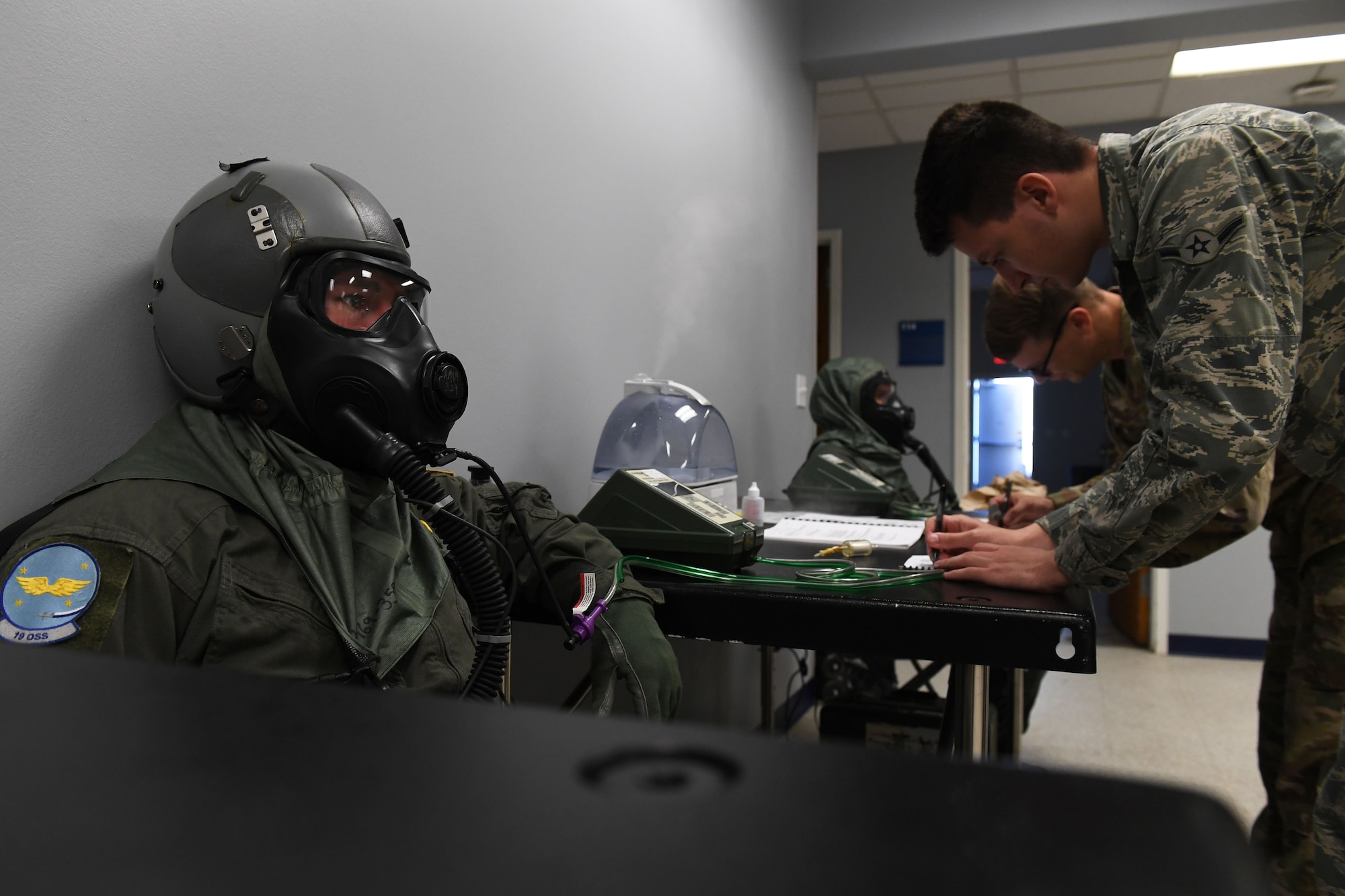 A pilot does a gas mask fit test