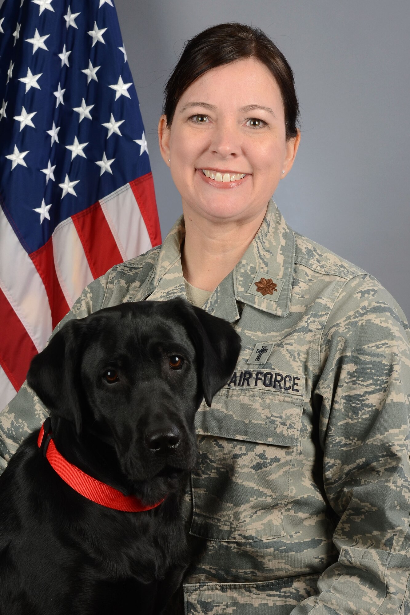 Portrait of U.S Air Force Maj. Christina Pittman, the 169th Fighter Wing chaplain, along with Avalon, the therapy assistance dog for ministry at McEntire Joint National Guard Base, South Carolina Air National Guard, March 19, 2019. (U.S. Air National Guard photo by Master Sgt. Caycee Watson)