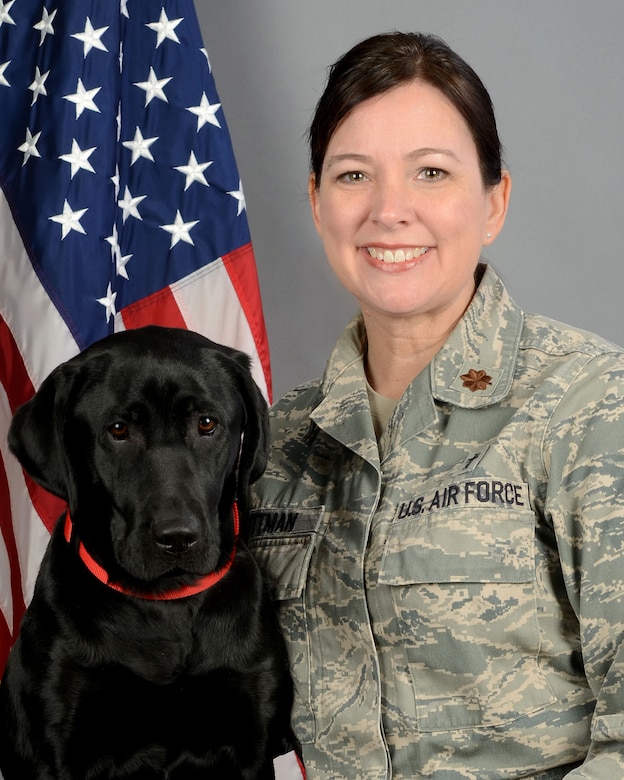 Portrait of U.S Air Force Maj. Christina Pittman, the 169th Fighter Wing chaplain, along with Avalon, the therapy assistance dog for ministry at McEntire Joint National Guard Base, South Carolina Air National Guard, March 19, 2019. (U.S. Air National Guard photo by Master Sgt. Caycee Watson)