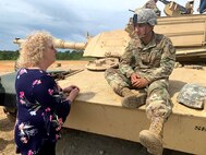 Ms. Kris Thomasian is a school board member on the  Murrieta Valley Unified District Board of Education in Murrieta, CA., She took a few moments to chat with a Soldier during a military vehicle static display.