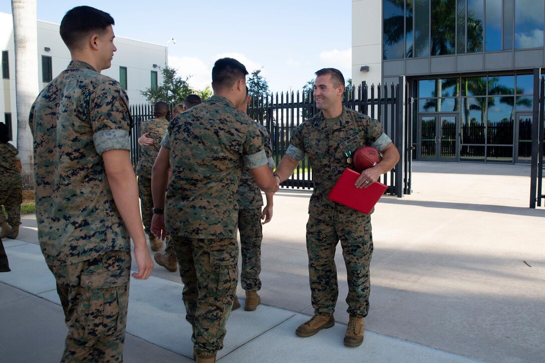 SSgt Zachary A. Fry shakes hands with U.S. Marine Corps Forces, South staff after getting the Mavy and Marine Corps Commendation Medal as his end of tour award, April 30, 2019.