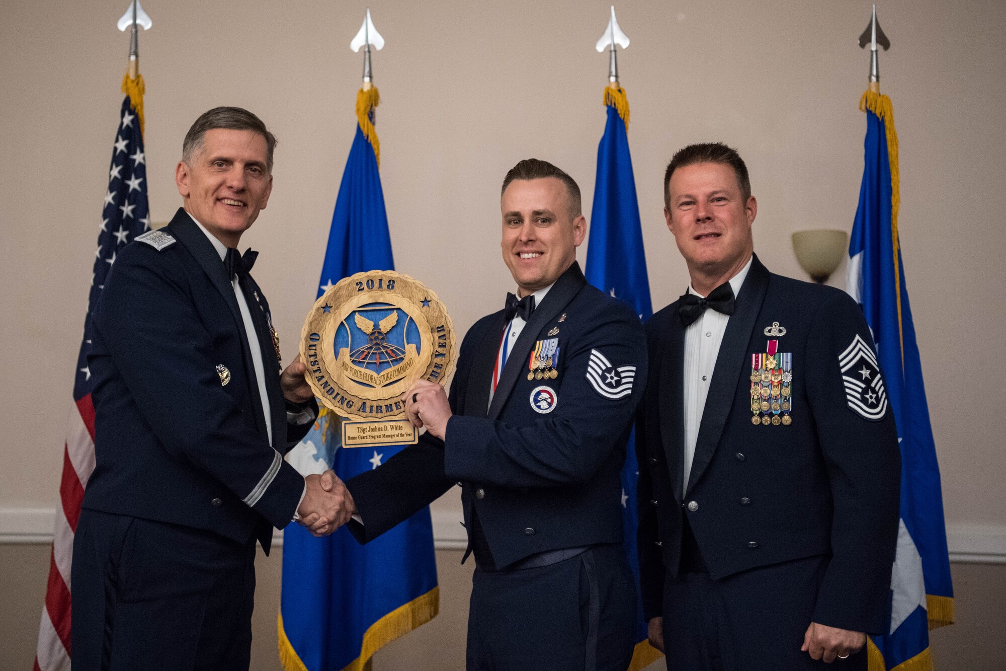 U.S. Air Force Tech. Sgt. Joshua D. White (middle), 509th Force Support Squadron non-commissioned officer-in-charge of the base honor guard at Whiteman Air Force Base, Mo., receives an Air Force Global Strike Command Outstanding Airmen of the Year award April 15, 2019, at Barksdale Air Force Base, La. The OAY award was awarded to six Airmen throughout AFGSC. (U.S. Air Force photo by Airman Jacob B. Wrightsman)