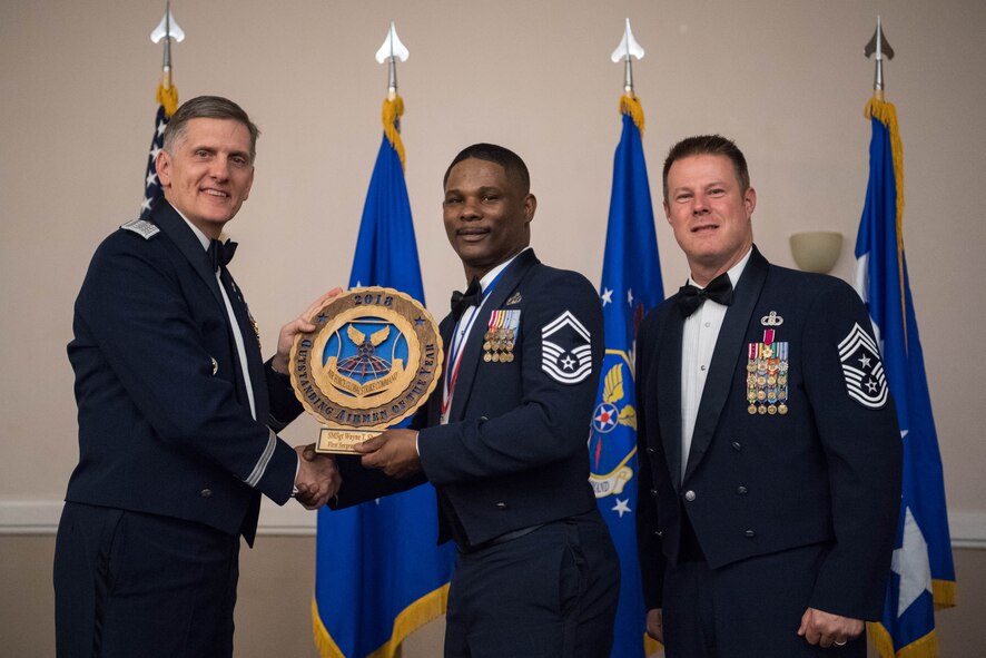 U.S. Air Force Senior Master Sgt. Wayne T. Sharp (middle), 5th Maintenance Squadron first sergeant at Minot Air Force Base, N.D., receives an Air Force Global Strike Command Outstanding Airmen of the Year award April 15, 2019, at Barksdale Air Force Base, La. The OAY award was awarded to six Airmen throughout AFGSC. (U.S. Air Force photo by Airman Jacob B. Wrightsman)