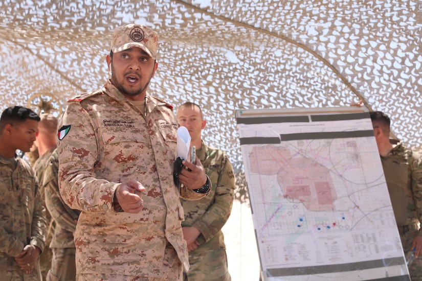 Kuwait Land Forces Lt. Col. Ahmad Alsanea addresses KLF soldiers following a sand table rehearsal demonstrated by U.S. Soldiers from the 3rd Battalion, 29th Artillery Regiment, 3rd Armored Brigade Combat Team, 4th Infantry Division, at a Camp Buehring, Kuwait training area on April 23, 2019. Alsanea said the participating KLF soldiers benefitted from the opportunity to train with their counterparts  and observe how U.S. forces plan and conduct training operations.