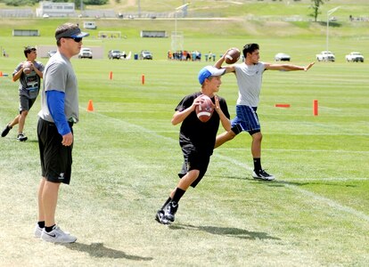 Youth sharpen their football skills during a youth football camp. Air Force Youth Programs is offering a variety of summer camps for 2019 to include more than 10 sports camps.