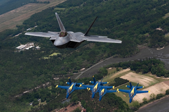 F-22s with Blue Angels