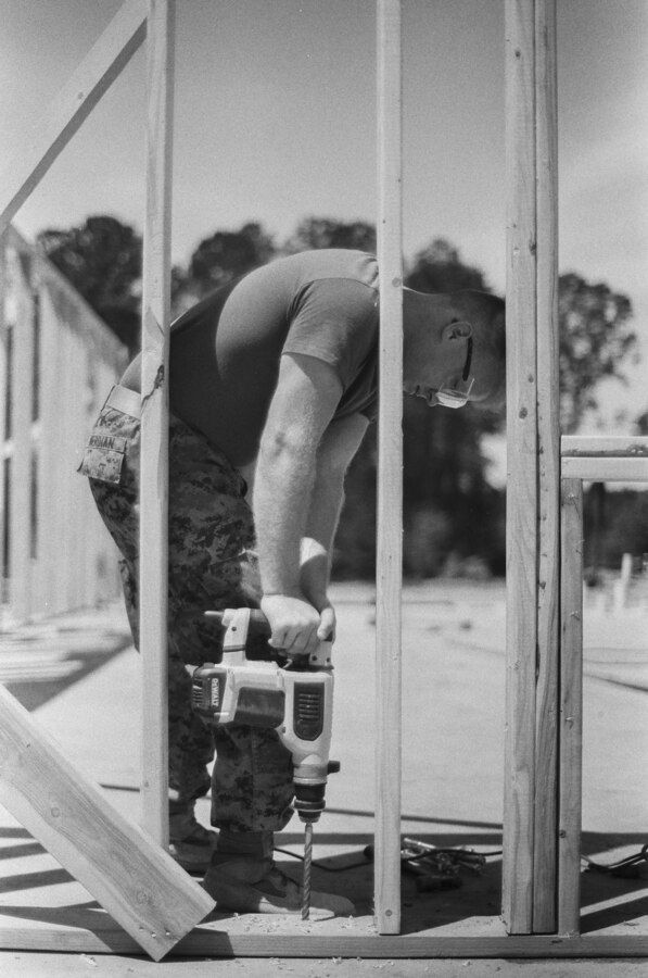 U.S. Marine Corps Lance Cpl. Zachary Merdian, a combat engineer with Company C, 6th Engineer Support Battalion, 4th Marine Logistics Group, Marine Forces Reserve, drills into the foundation of a cabin during the Innovative Readiness Training Camp Kamassa, near Crystal Springs, Miss., April 22. 2019. The purpose of the Department of Defense’s IRT program is to support the community by pairing military members with civil projects that benefit the community, and enables Marine Reserve units to increase their efficiency and performance. (U.S. Marine Corps 35mm film photo by Cpl. Niles Lee)