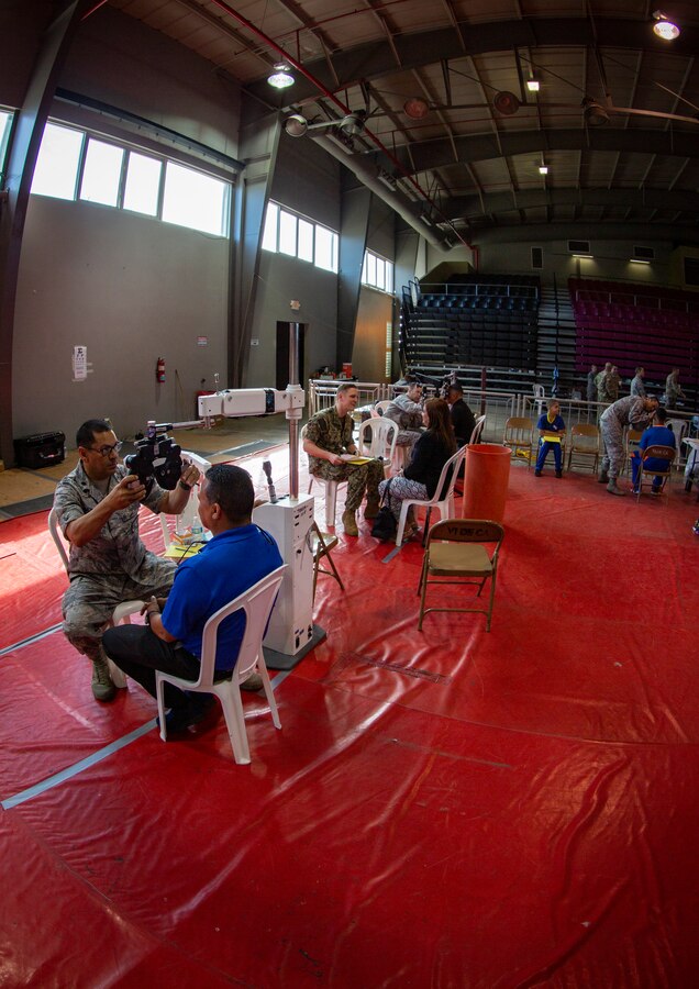 U.S. service members examine patients’ vision at Ponce, Puerto Rico, May 1, 2019, during Innovative Readiness Training Puerto Rico. IRT Puerto Rico is also called Ola de Esperanza Sanadora, which translates to Healing Wave of Hope. This IRT is part of a civil and joint military program to improve military readiness while simultaneously providing quality services to underserved communities throughout the United States. (U.S. Marine Corps photo by Sgt. Andy O. Martinez)