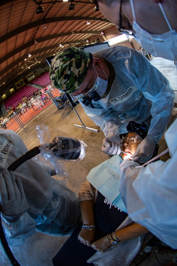 U.S. Navy Cmdr. Michael Cabassa, a general dentist with 4th Dental Battalion, 4th Marine Logistics Group, Marine Forces Reserve, conducts a tooth extraction on a patient at Ponce, Puerto Rico, May 1, 2019, during Innovative Readiness Training Puerto Rico. IRT Puerto Rico is also called Ola de Esperanza Sanadora, which translates to Healing Wave of Hope. MARFORRES is participating in IRT Puerto Rico 2019 in order to maintain military readiness while strengthening alliances with community partners. (U.S. Marine Corps photo by Sgt. Andy O. Martinez)