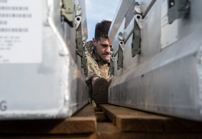U.S. Air Force Senior Airman Gabriel Walker, 3rd Munitions Squadron munitions stockpile management crew chief, reads serial numbers during the Spring Ammunition Barge arrival at Joint Base Elmendorf-Richardson, Alaska, April 24, 2019. The ammo barge contained six containers and over 50,000 pounds of munitions.