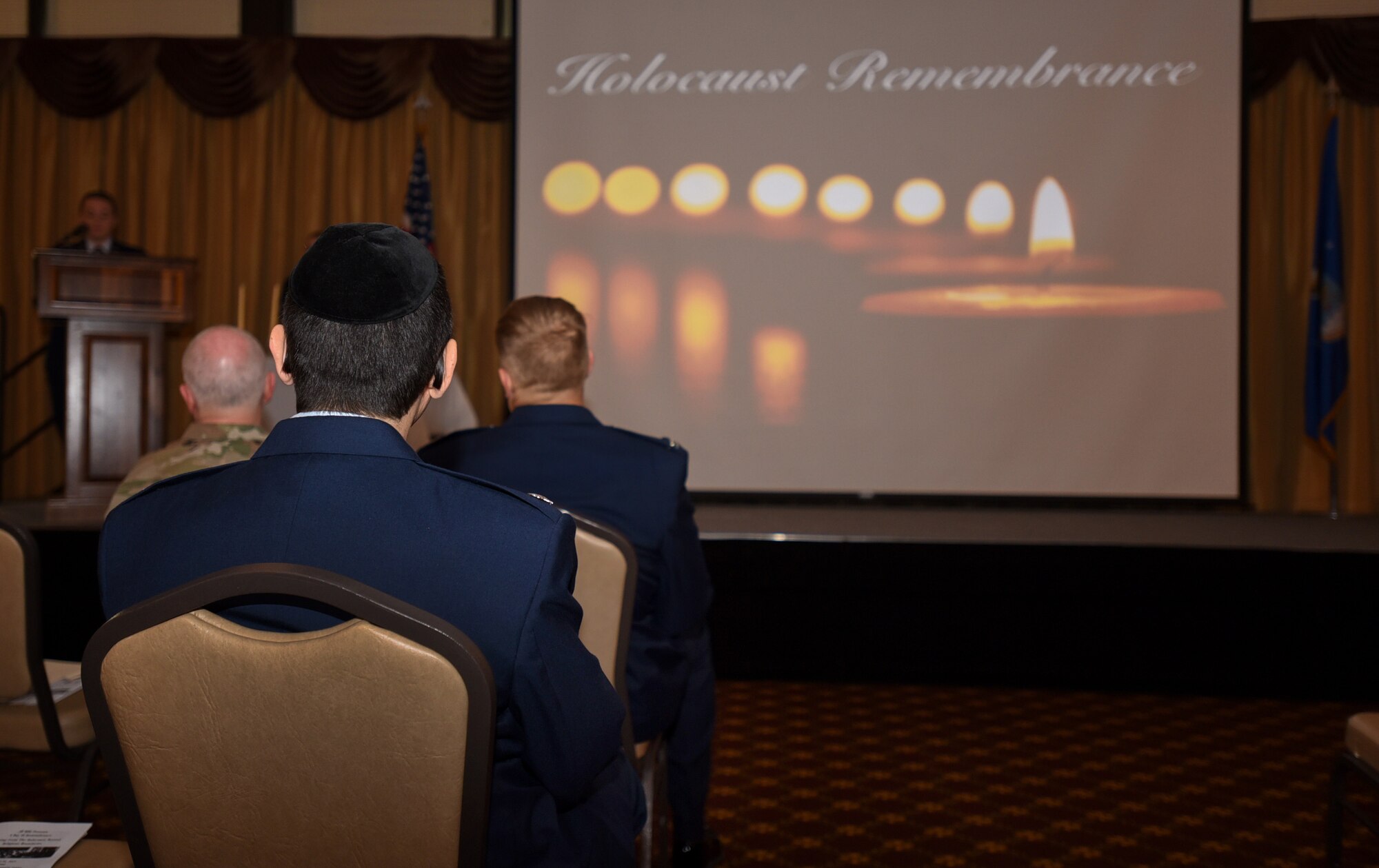 U.S. Air Force chaplain Lt. Col. Menashe Miller, 87th Air Base Wing captain chaplain, sits during the 2019 A Day of Remembrance ceremony on Joint Base McGuire-Dix-Lakehurst, New Jersey, April 30, 2019. Miller was selected to give the invocation because his Jewish faith corresponds with the events of the Holocaust. (U.S. Air Force photo by Airman 1st Class Ariel Owings)