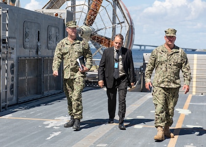 Dave Vickers, Expeditionary Systems Division head, and Master Chief Petty Officer Stephen Lowe, gas turbine system technician, give Commander, Naval Sea Systems Command Warfare Centers Rear Adm. Eric Ver Hage, a tour of a Landing Craft Air Cushion during his tour of Naval Surface Warfare Center Panama City Division May 1.