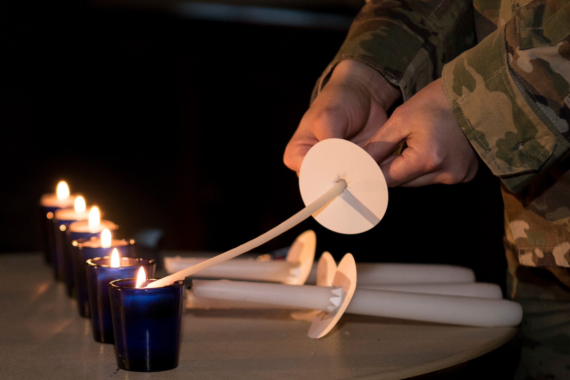 Technical Sgt. Kristen Pujol, 374th Force Support Squadron fitness plans and programs nco in charge lights candles, May 2, 2019, at Yokota Air Base, Japan