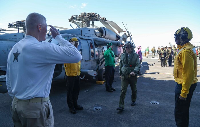 Rear Adm. John Wade, commander, Carrier Strike Group 12 (left), greets President Ilir Meta of Albania, on the flight deck of the Nimitz-class aircraft carrier USS Abraham Lincoln (CVN 72).