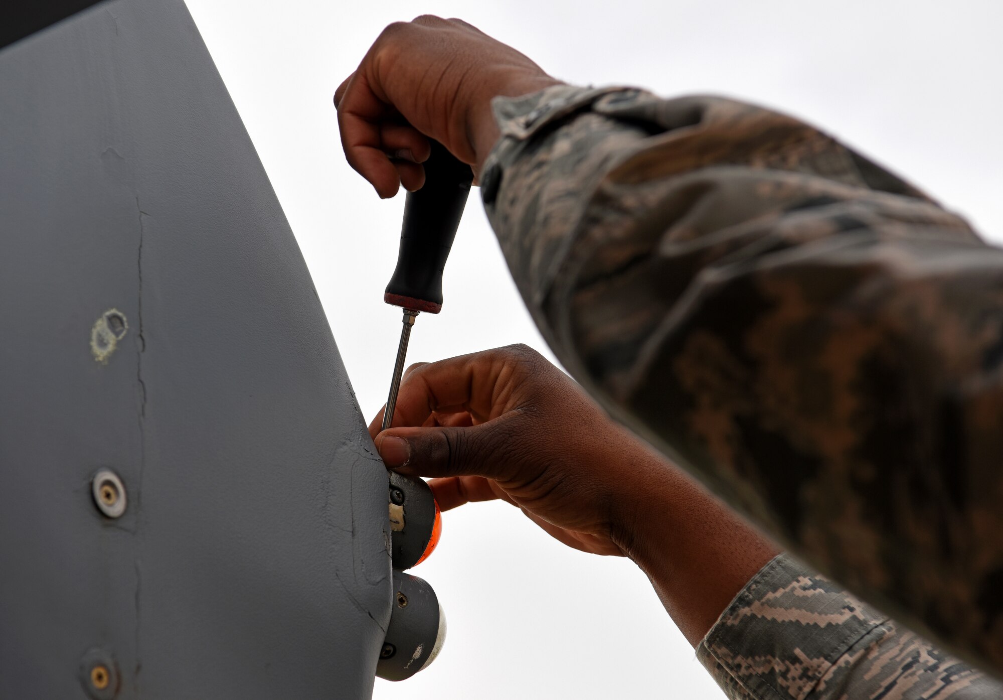 U.S. Air Force Airman 1st Class Santonio Portis, 100th Aircraft Maintenance Squadron aircraft electrical and environmental apprentice, repairs lights aboard a KC-135 Stratotanker at RAF Mildenhall, England, May 2, 2019.  During upgrade training, Airmen must complete tasks such as the recovery of aircraft, call flight controls prior to a launch and marshaling aircraft. (U.S. Air Force photo by Airman 1st Class Brandon Esau)
