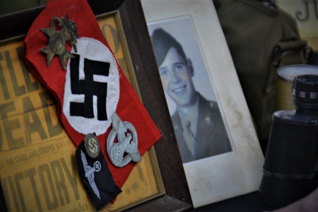 Nazi and Allied Forces reproductions are laid out on a table