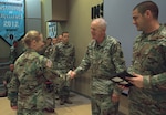 Maj. Gen. Timothy Sheriff, commander of the 263rd Army Air and Missile Defense Command hands graduation certificates to the 12 Soldiers of the 164th Air Defense Artillery Brigade who completed the Patriot Training Program, designed to teach Army National Guard air defenders how to properly integrate systems such as Patriot Surface to Air Missiles and THAAD (Terminal High Altitude Area Defense) within their commands, during a ceremony at Camp Blanding Joint Training Center.