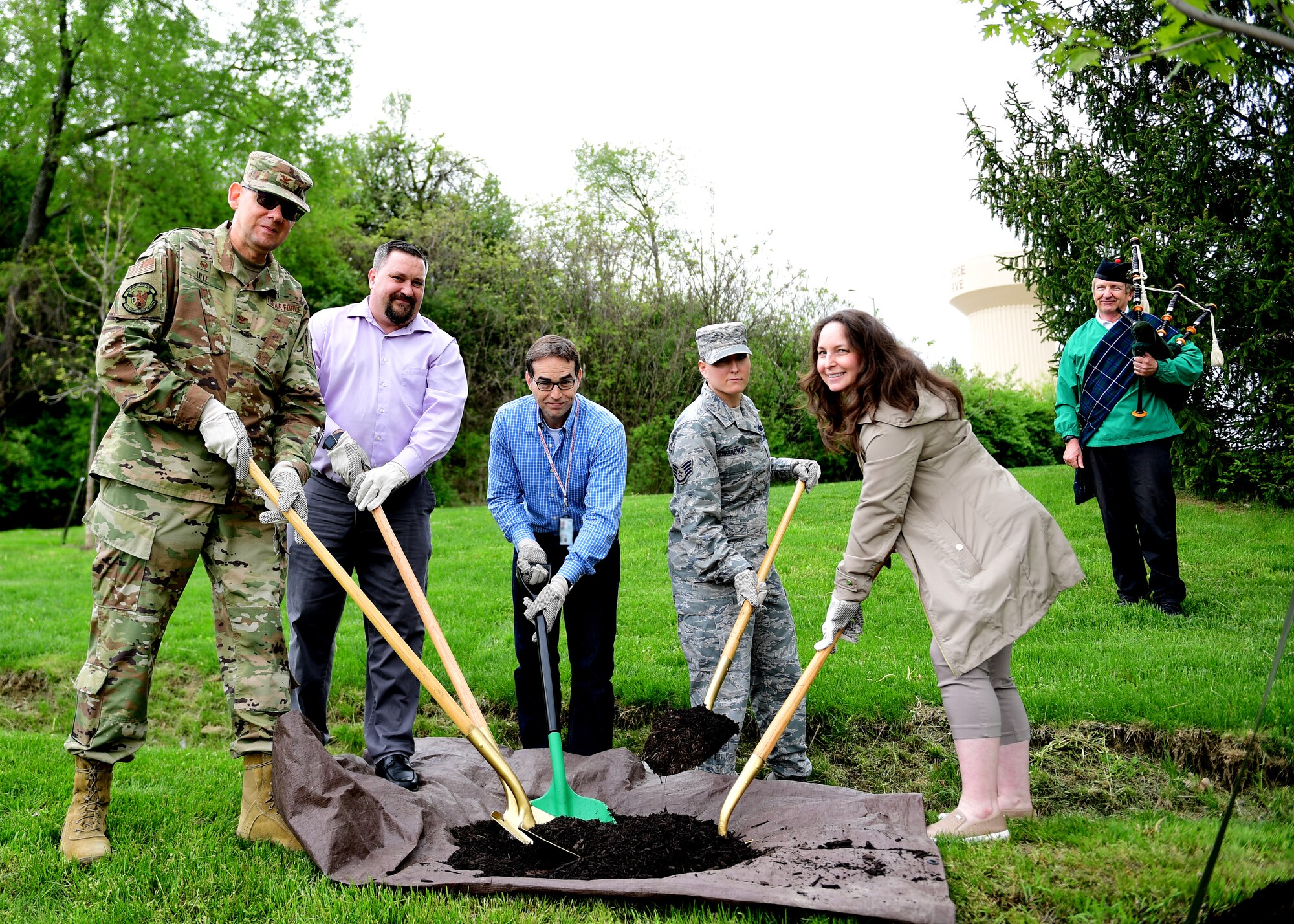 Personnel assigned to the 911th Airlift Wing, pose after planting a tree at the Pittsburgh International Airport Air Reserve Station, Pennsylvania, May 2, 2019. Every year the 911th AW celebrates Earth Day with a tree planting ceremony to symbolize the Air Force Reserve’s commitment to environmental sustainability.  (U.S. Air Force Photo by Senior Airman Grace Thomson)