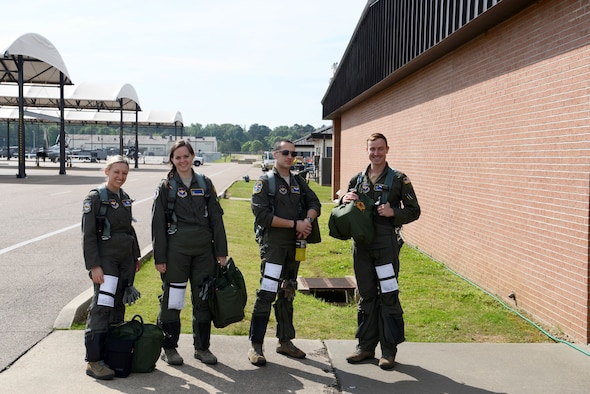 A group of pilots from the 37th and the 41st Flying Training Squadrons stand ready in front of the flight line May 1, 2019, on Columbus Air Force Base, Mississippi. Both squadrons train student pilots on the T-6 Texan ll where they will learn basic aircraft features and controls. (U.S. Air Force photo by Airman 1st Class Jake Jacobsen)