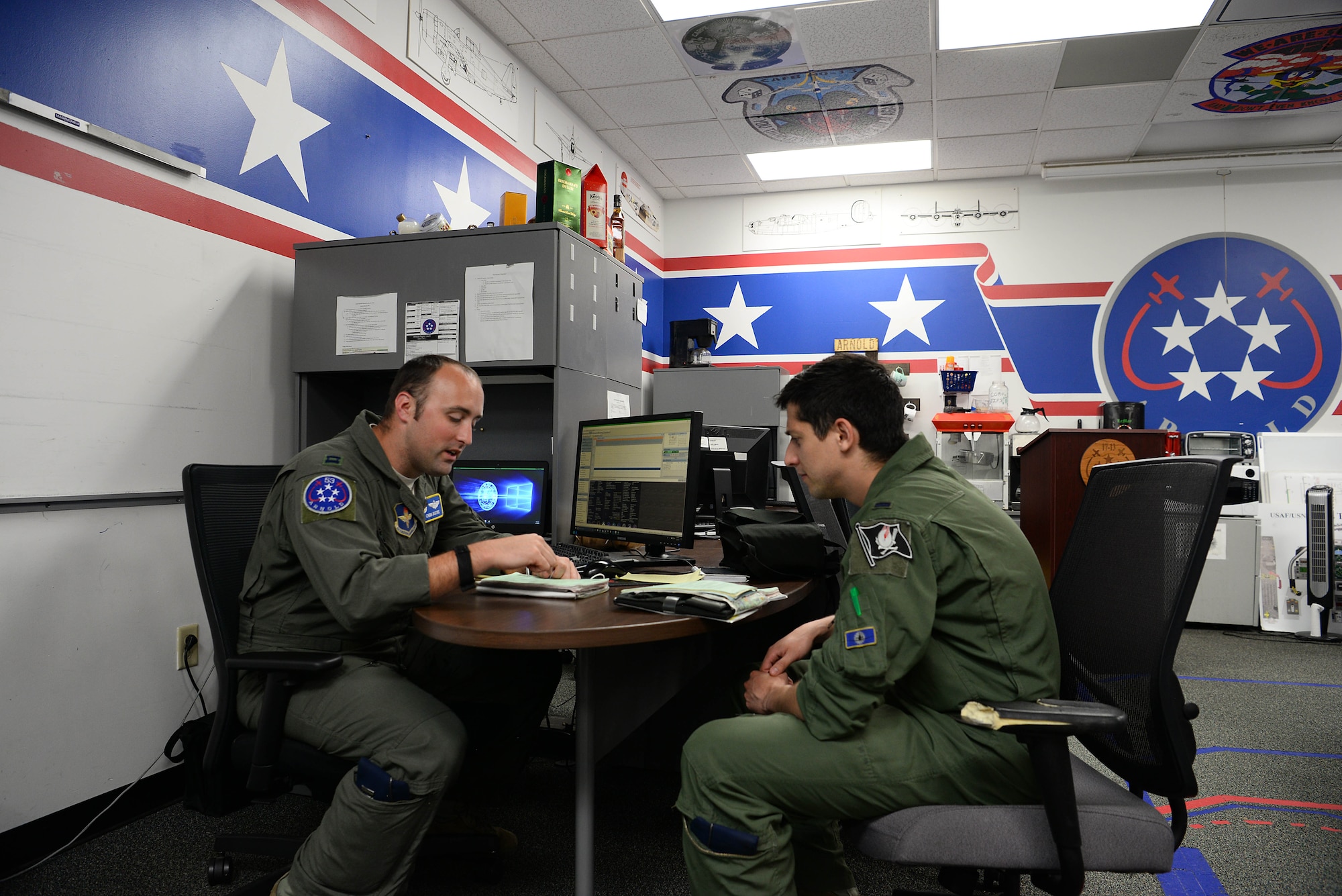 Capt. Chris Bodtke, 41st Flying Training Squadron chief of safety, and 1st Lt. Arron Bellini, Arnold Flight USEM, discuss plans for progressing the Arnold Flight. May 1, 2019, on Columbus Air Force Base, Mississippi. The 41st FTS train pilots for real scenarios by going over fight plans and develop solutions. (U.S. Air Force photo by Airman 1st Class Jake Jacobsen)
