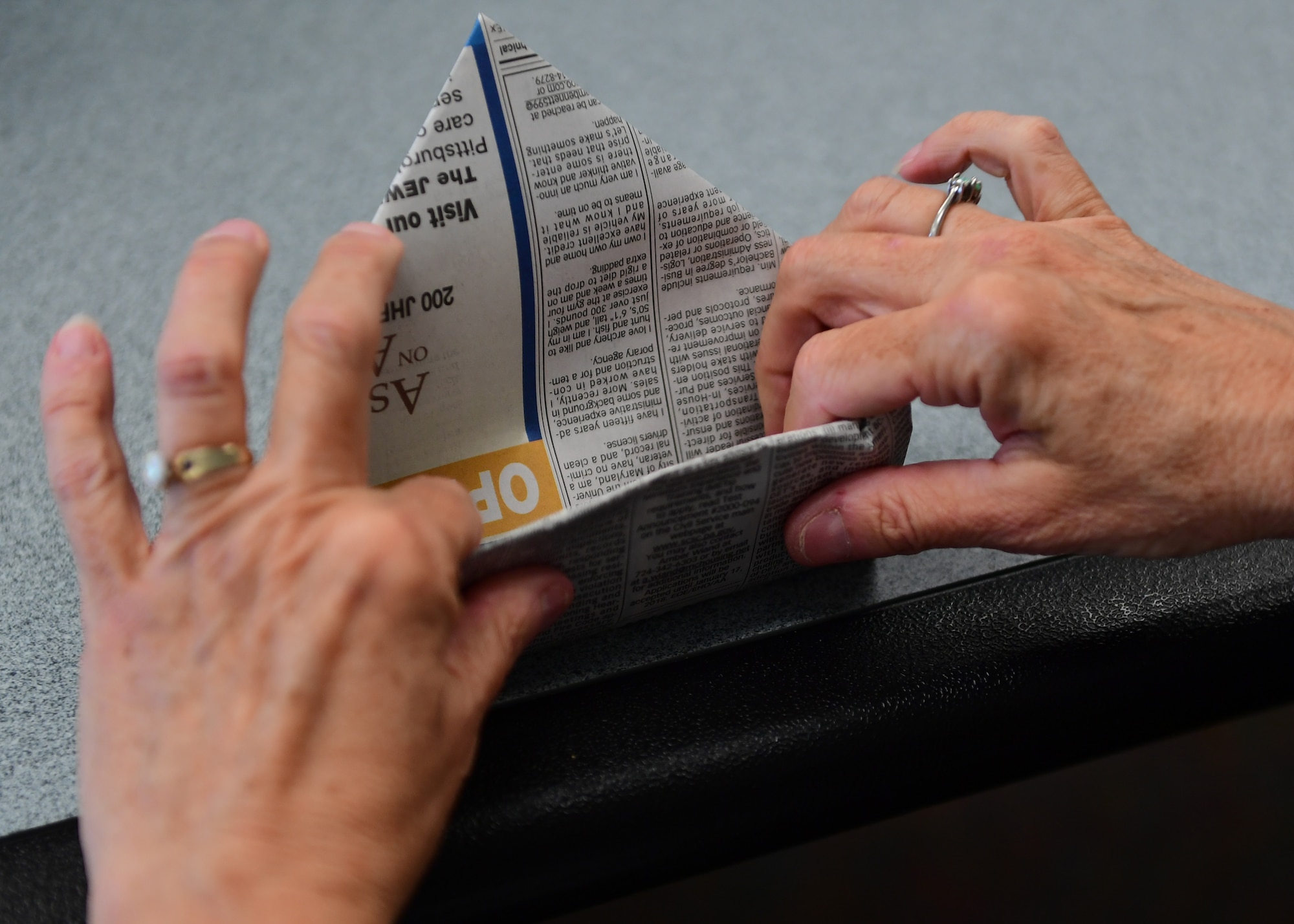 Debbie Vasko, 911th Force Support Squadron marketing assistant, finishes her newspaper pot at the Pittsburgh International Airport Air Reserve Station, Pennsylvania, May 2, 2019. After the pots were done, the attendees were able to put soil and seeds in the pots to take home and grow. (U.S. Air Force Photo by Senior Airman Grace Thomson)