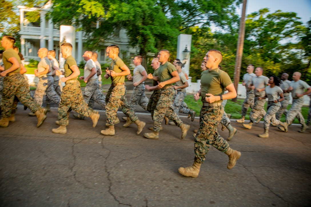 Marines and Airmen conduct a motivational run at Crystal Springs, Miss., on April 26, 2019. The Marines and Airmen are part of the Department of Defense’s Innovative Readiness Training Camp Kamassa near Crystal Springs. The program supports the community by pairing military members with civil projects that benefit the community, and enables Marine Reserve units to increase their efficiency and performance. (U.S. Marine Corps photo by Lance Cpl. Jose Gonzalez)