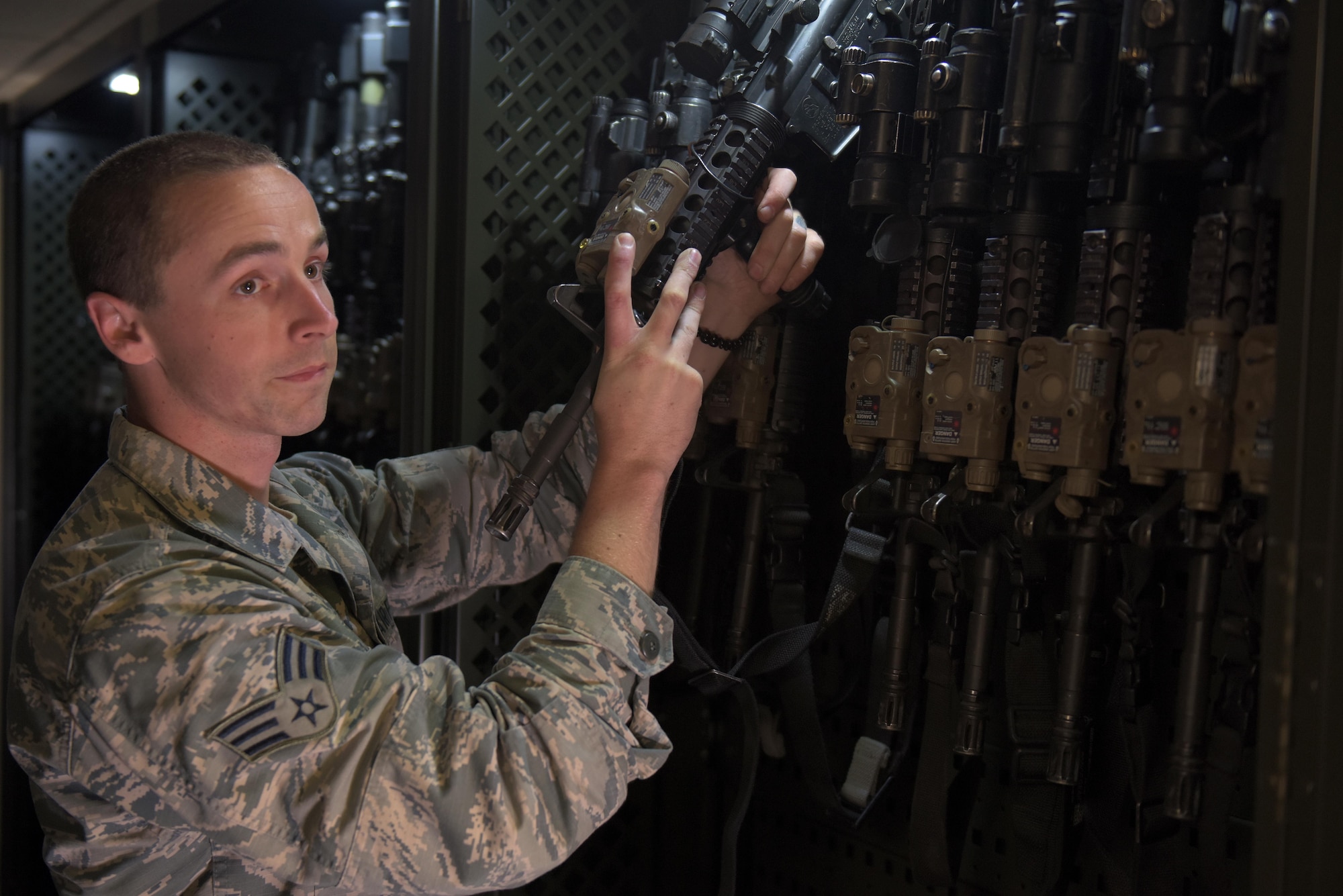 U.S. Air Force Senior Airman Christopher Francis, 100th Security Forces Squadron armorer, retrieves an assigned weapon in the armory at RAF Mildenhall, England, May 2, 2019. Each Security Forces flight member has an assigned M-4 carbine and M-9 Beretta specific to that Airman. (U.S. Air Force photo by Senior Airman Benjamin Cooper)