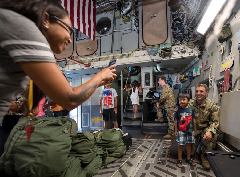 An Airman poses for a photo during a tour of a C-17 Globemaster III