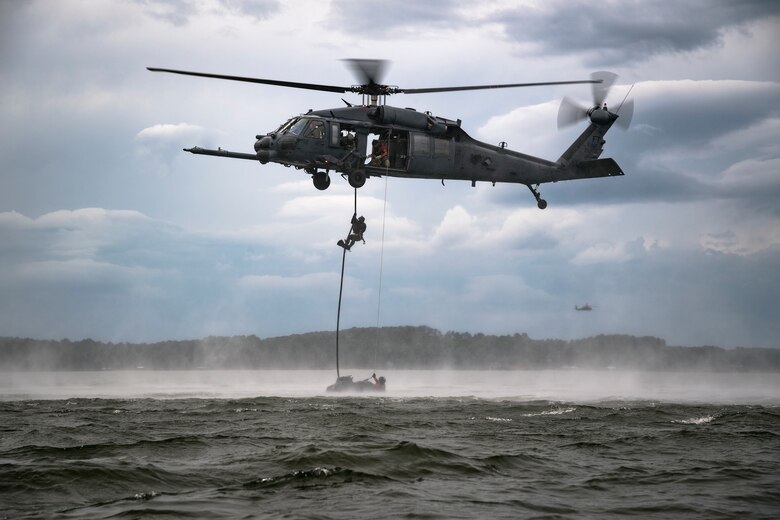 A pararescueman assigned to the 38th Rescue Squadron, Moody Air Force Base, Ga. fast-ropes from an HH-60G Pave Hawk