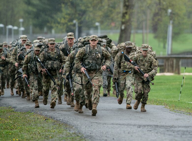 Soldiers and Airmen take off running for a six-mile ruck march