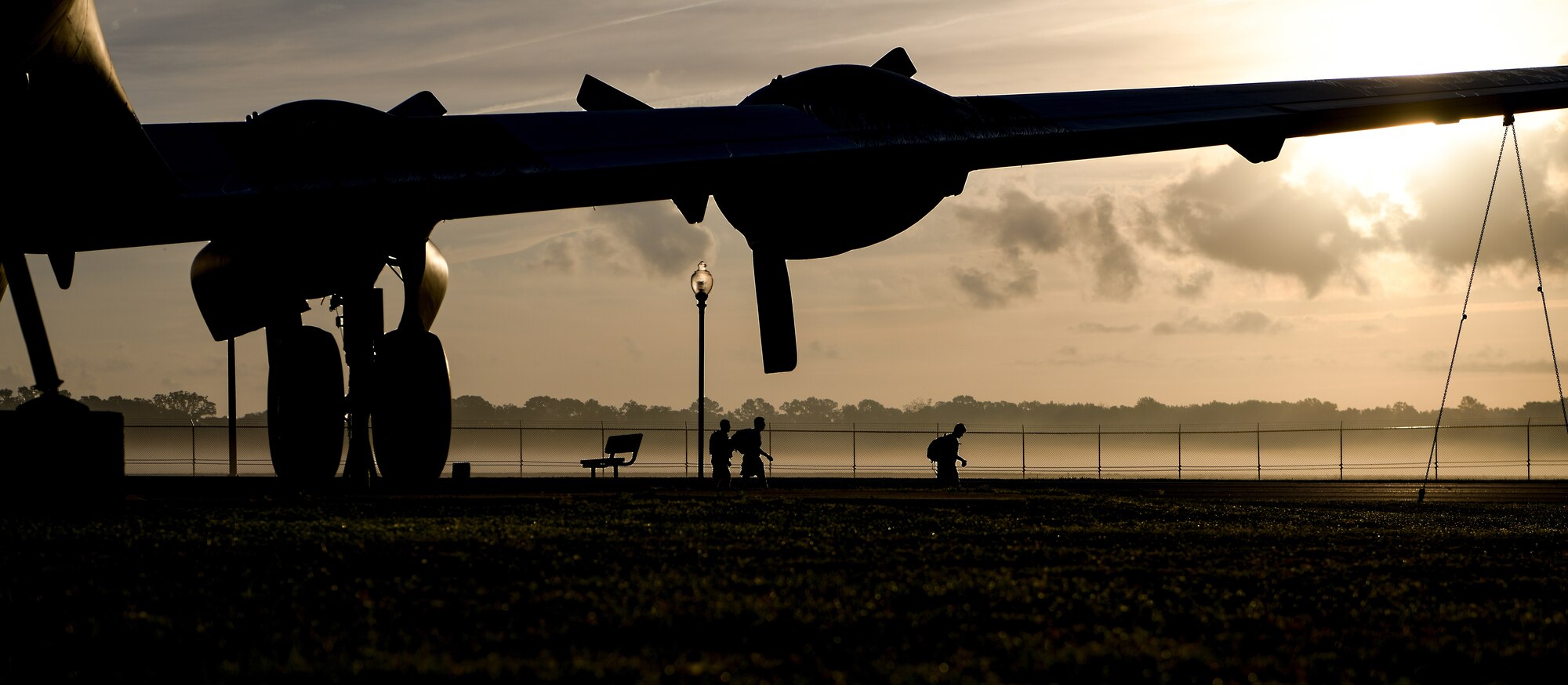 Airmen ruck march along a running trail