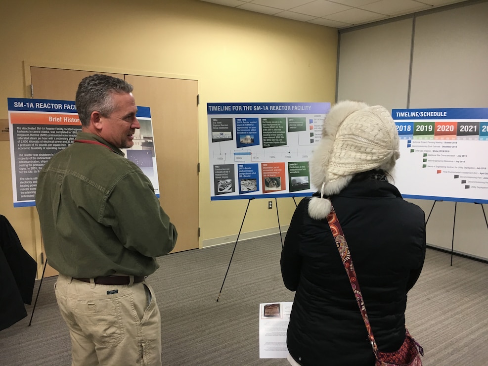 U.S. Army Corps of Engineers Radiological Health Physicist Hans Honerlah speaks with a member of the Fort Greely community at an on-post community update meeting Tuesday evening April 23, 2019, where Fort Greely stakeholders had an opportunity to learn more about the planning for the decommissioning of the SM-1A deactivated nuclear power plant. The SM-1A project team is committed to transparently sharing accurate information in a timely manner throughout the course of the project and among all relevant parties, making sure concerns among stakeholders are quickly addressed.