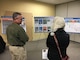 U.S. Army Corps of Engineers Radiological Health Physicist Hans Honerlah speaks with a member of the Fort Greely community at an on-post community update meeting Tuesday evening April 23, 2019, where Fort Greely stakeholders had an opportunity to learn more about the planning for the decommissioning of the SM-1A deactivated nuclear power plant. The SM-1A project team is committed to transparently sharing accurate information in a timely manner throughout the course of the project and among all relevant parties, making sure concerns among stakeholders are quickly addressed.