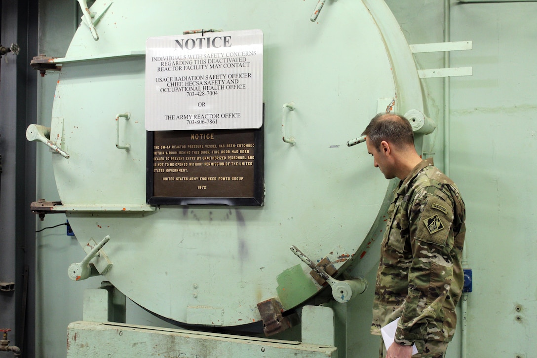 U.S. Army Corps of Engineers, Baltimore District commander Col. John Litz examines the containment vessel door of the SM-1A Deactivated Nuclear Power Plant April 24, 2019 during a site visit. SM-1A will be decommissioned and dismantled by the U.S. Army Corps of Engineers, Baltimore District, with its Radiological Center of Expertise, and in partnership with Fort Greely Garrison and Alaska District. Part of this dismantling and decommissioning effort will involve segregating components of the co-located, still operational steam plant from where the decommissioning will take place.