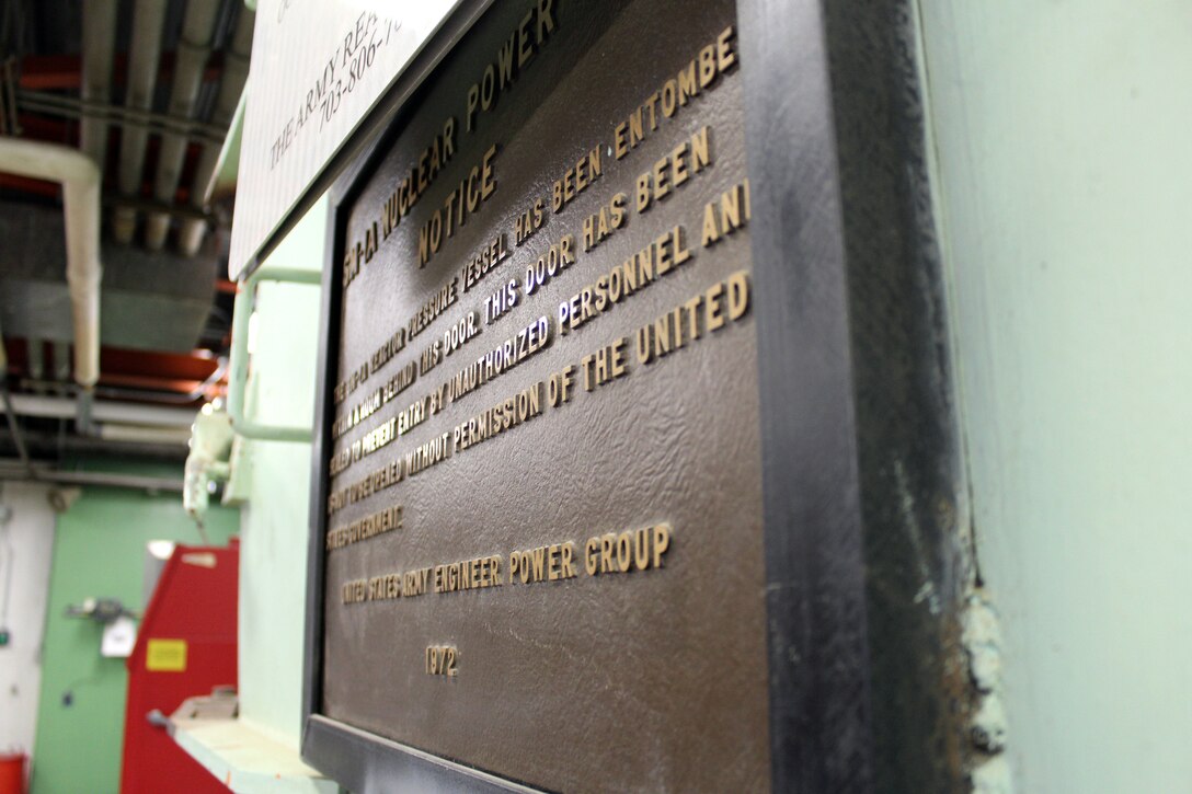 A plaque signifying the SAFSTOR of the containment vessel of the SM-1A Deactivated Nuclear Power Plant is featured during a site tour April 24, 2019. Located at Fort Greely, the SM-1A Deactivated Nuclear Power Plant is in the planning stage of being decommissioned and dismantled. Part of this effort will involve segregating components of the co-located, still operational steam plant from where the decommissioning will take place. U.S. Army Corps of Engineers, Baltimore District, with its Radiological Center of Expertise, and Alaska District personnel are working together closely in partnership on the SM-1A decommissioning at Fort Greely in Alaska.