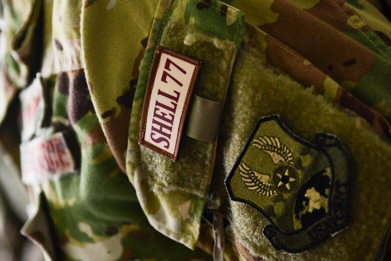 A Shell 77 patch rests on the sleeve of an Airman form the 22d Expeditionary Air Refueling Squadron during a memorial ceremony, May 3, 2019, at Incirlik Air Base, Turkey. In conjunction with the memorial ceremony, 22d EARS Airmen flew commemorative flags for aircrew of Shell 77 on a KC-135 Stratotanker from Fairchild Air Force Base, Wash. The flags will later be presented to the families of the three fallen heroes. (U.S. Air Force photo by Staff Sgt. Ceaira Tinsley)
