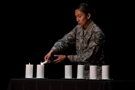 Staff Sgt. Cheree Voto, 628th Aerospace Medicine Squadron aerospace medic, lights a candle in remembrance of the Holocaust for Holocaust Remembrance Week May 2, 2019, at Joint Base Charleston, S.C.
