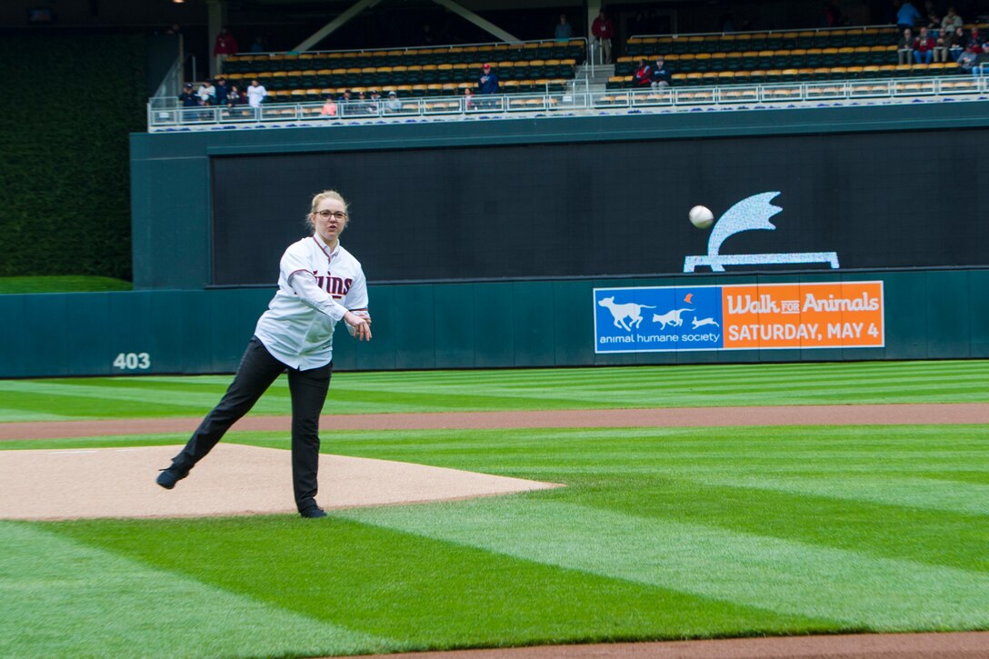 Staff Sgt. Sydney Whiteis, assigned to the 934th Security Forces Squadron, threw out the ceremonial first pitch before the start of the Minnesota Twins Major League Baseball game against the Houston Astros at Target Field in Minneapolis, Minn., May 2, 2019.  Two hours before the game, Whiteis was surprised to learn she was selected to throw out the opening pitch.