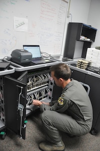 2nd Lt. Lucas Erickson, 12th Training Squadron student pilot and electronic flight bag technician, organizes iPad tablets in a specialized charging and upload cabinet, May 3, 2019, Joint Base San Antonio-Randolph, Texas. The team at 12th TRS uses this equipment to expedite the issue and maintenance of the EFB inventory across JBSA-Randolph.