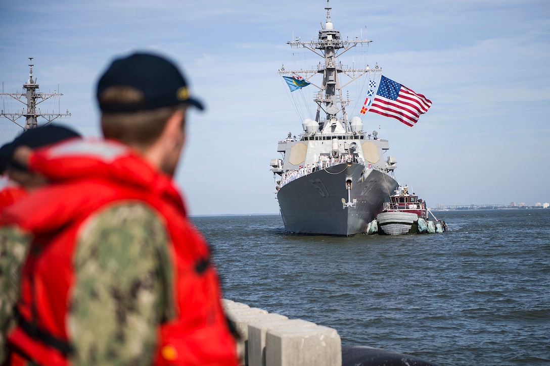 A ship returns to a Naval station.