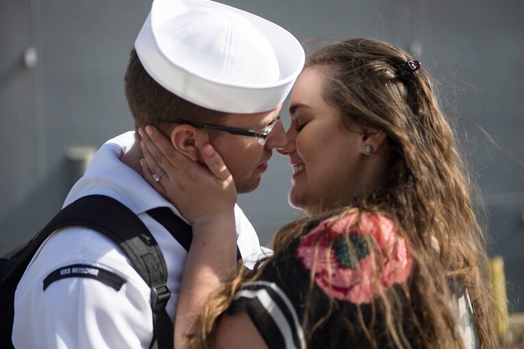 A sailor embraces a loved one.