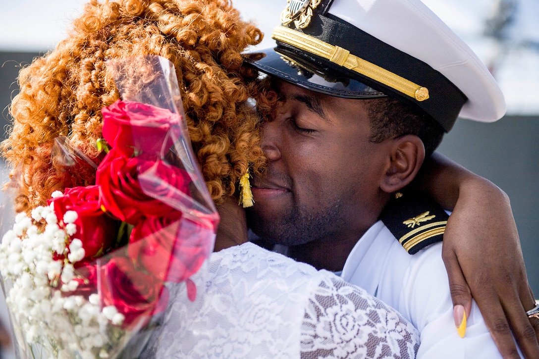 A sailor embraces his wife.